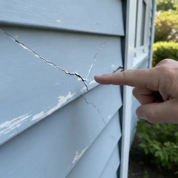 Close-up of damaged siding requiring evaluation